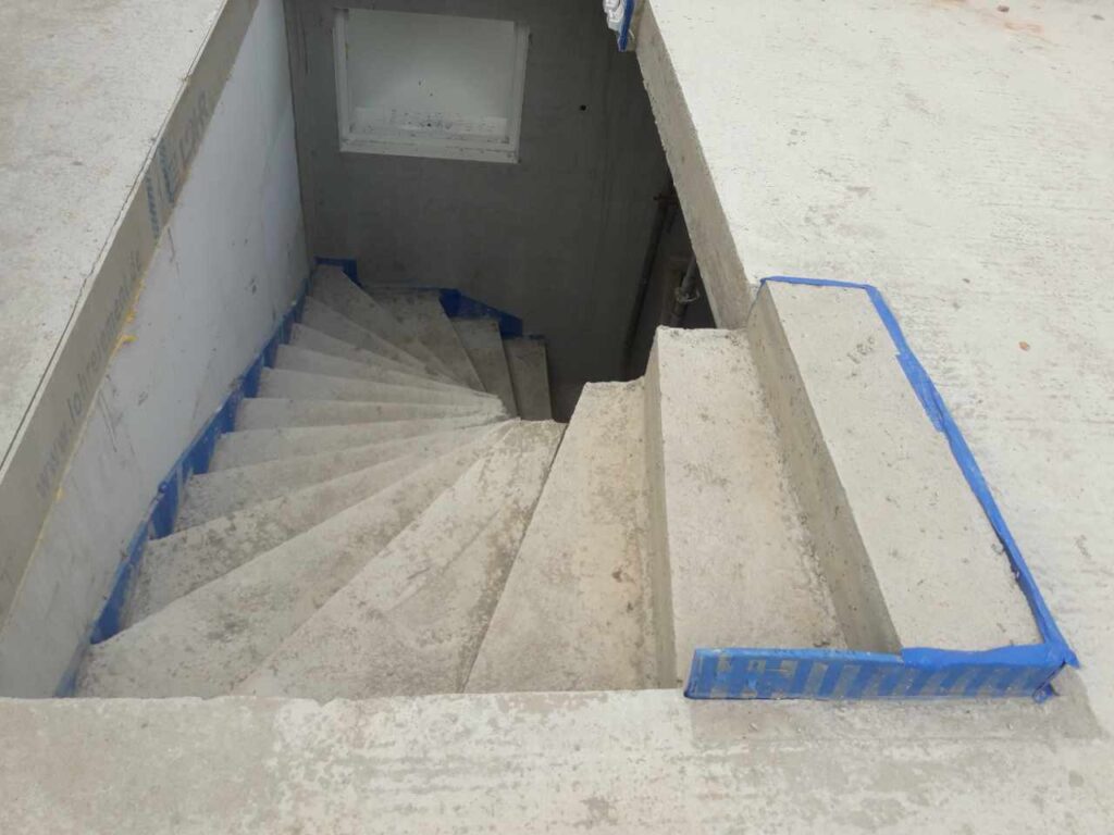 Betonfertigtreppe im Rohbau, Stufen durch Folie geschützt.